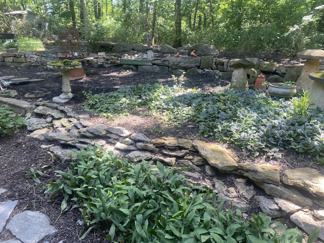 Layered stone retaining walls and planted garden beds